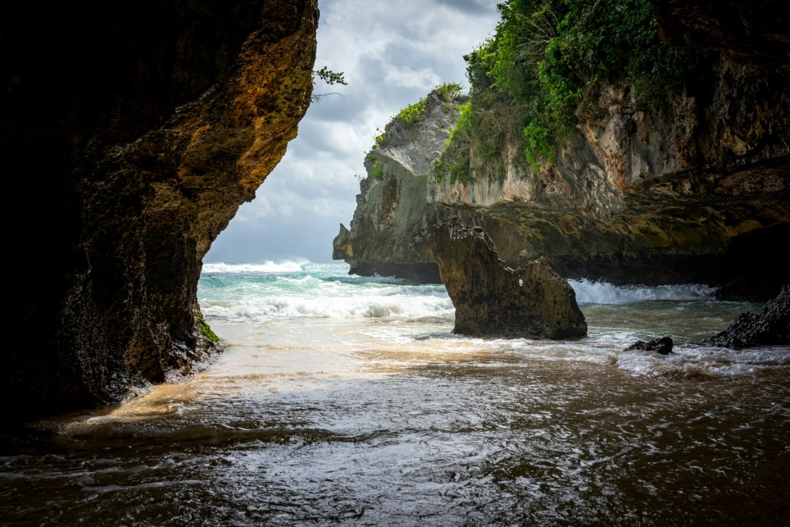 brown rock formation near body of water during daytime